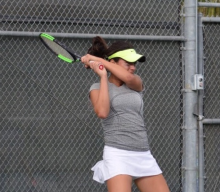During practice at Cathedral Catholic High School, Sophie Raiszadeh ‘19 lines up to practice her backhand technique.