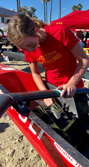 Jenna Crowley ‘22 prepares to row in the Vespoli four-seat boat with the CCHS novice crew team at the Long Beach Christmas Regatta on Sunday. The novice team rowed 850 meters in the Long Beach Maritime Stadium and placed second in the event. 
