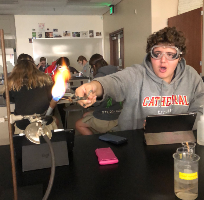 Watching in awe as the flame changes colors with each salt sample, Cathedral Catholic High School student, Lukas Fuster ‘21, places the metal into the fire and observes the reaction, learning more about the energy of electrons. 

