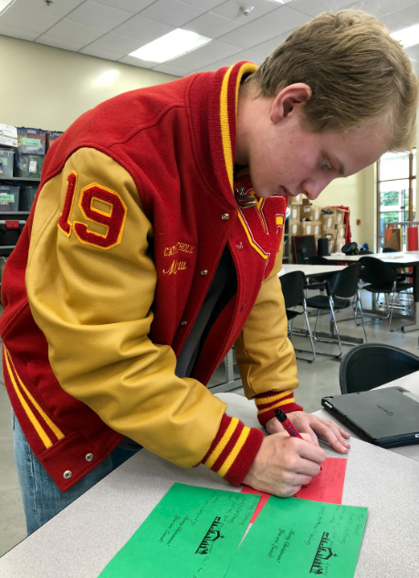In the spirit of Christmas, Matthew Limber ‘19 makes festive Christmas Santa grams on Friday. Each gram has a picture of the nativity scene and reads “Merry Christmas! You are loved” to spread a positive message friends can appreciate throughout the season. 

