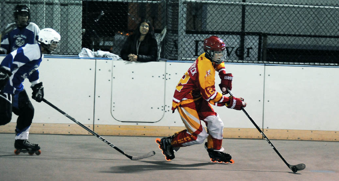 Defender Ben Rodenbeck ‘20 moves the puck down the rink and to the forwards to score.