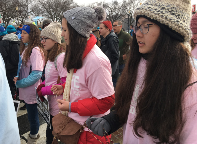 Marilyn Hobrock ‘20 (right) leads the rosary as she marches beside her fellow Dons for Life, Kate Fernandez ‘20, Lucille Bacich ‘22, and Cecilia Bacich ‘20 (right to left), in the 46th annual March for Life in Washington D.C. The 2019 March for Life attracted an estimated more than 200,000 people, including 25 Cathedral Catholic High School students, teachers, and parents. 

