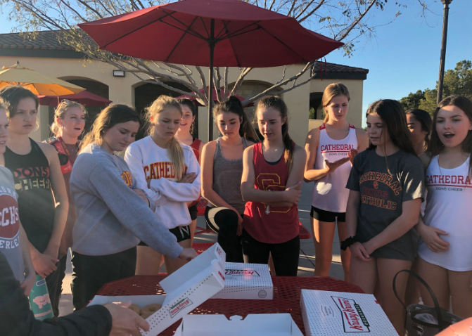 Both varsity cheer and JV cheer teams celebrate Mrs. Amber Elliot’s birthday last Wednesday after practice with donuts provided by Shea Simons ‘21 and her mother Dawn Simons. 
