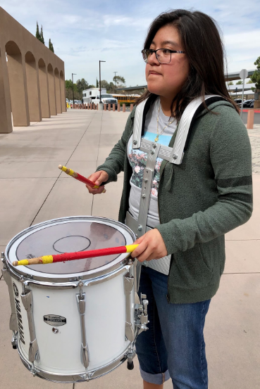 Thrilling CCHS students with her quick and upbeat drum rhythms, Alejandra Hidalgo ‘20 leads the drum line before Friday’s winter sports rally. Hidalgo’s green sweater supports her junior class, as all students dressed to represent their designated grade’s color at the rally.
