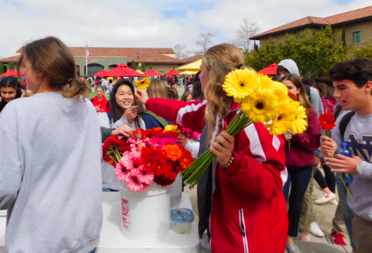 CCHS student Hailey Colman ‘19 passes a flower to Olivia Sung ‘19 as a part of Life Week’s Celebrate Life Friday, a day that hopes to inspire happiness around campus and celebrate all life. 