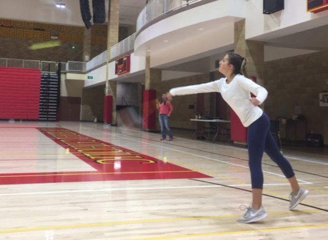 Ali Viana ‘20 practices a serve in the Claver Center during the last day of badminton tryouts in hopes of making the varsity team.