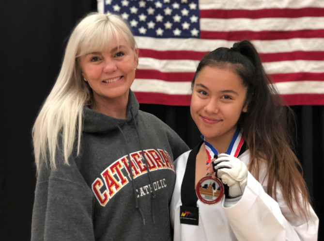 Olivia Palombo ‘21 and her coach Master Patricia Church celebrate after Palombo finished second at the National Collegiate Taekwondo High School Collegiate Nationals at The University of Texas at Austin, falling by a score of 10-11 in the final match.
