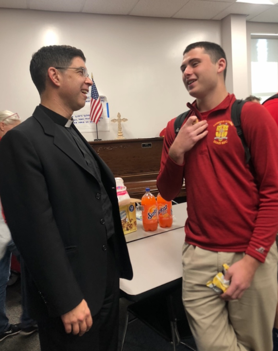 Saying a heartfelt goodbye, Cathedral Catholic High School student Joseph Orlando ‘19 chats with Fr. Patrick Wainwright at his going away party.
