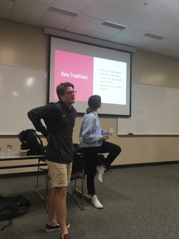 Adam LeClair '20 elaborates on the new Los Locos traditions for the 2019-2020 football season. LeClair, a core member of the support squad, additionally addressed the former behavior and traditions which will be discontinued, including the crowd turning their back to the opponent, and throwing baby powder. A large group gathered to listen to the Los Locos leaders speak, and they all practiced chants in the lecture hall to conclude the meeting.