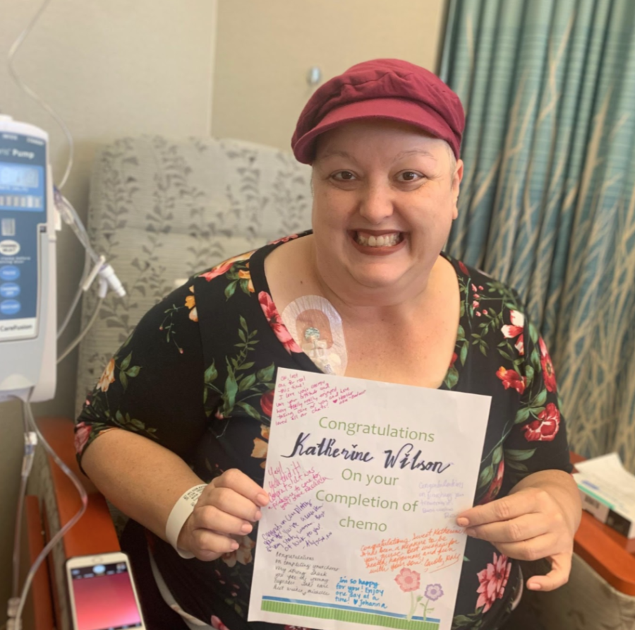 Miss Wilson poses with a get well card after a scheduled chemotherapy treatment before her eventual cancer-free diagnosis. 