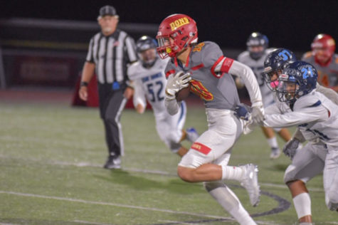 Cathedral Catholic High School varsity football team wide receiver Harry Balke ‘21 pulling away from defenders in the Dons 63-0 victory last Friday against Otay Ranch High School. 