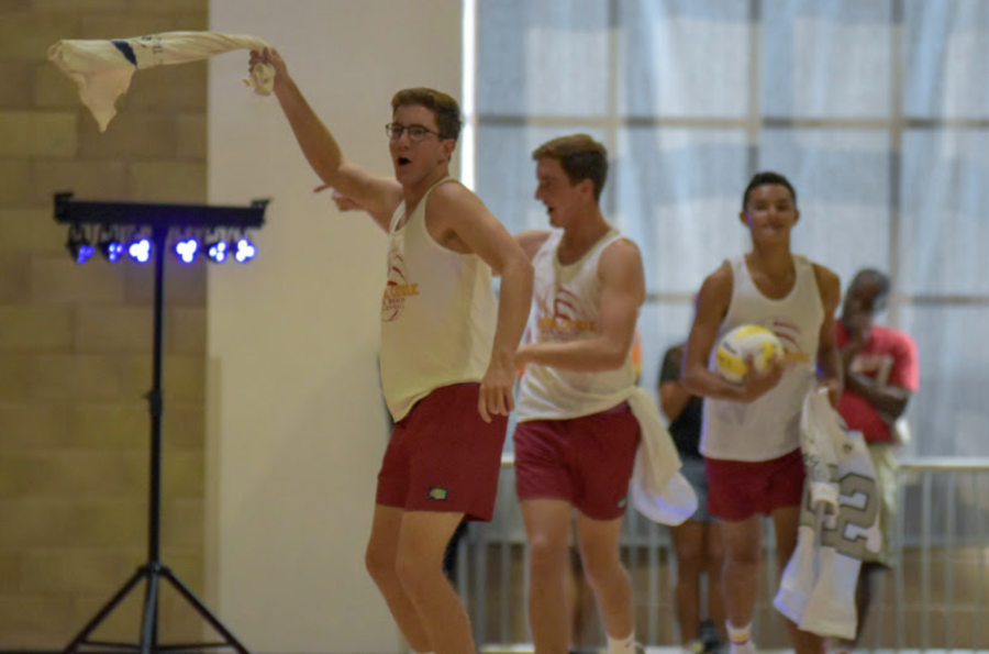 Cameron Nash ‘20, Nate Nash ‘20, and Jackson Reed ‘20 (left to right) run out during the short showcase for the boys sand volleyball team showcase during Octobers fall sports rally with their t-shirt turned rally towels in hand.