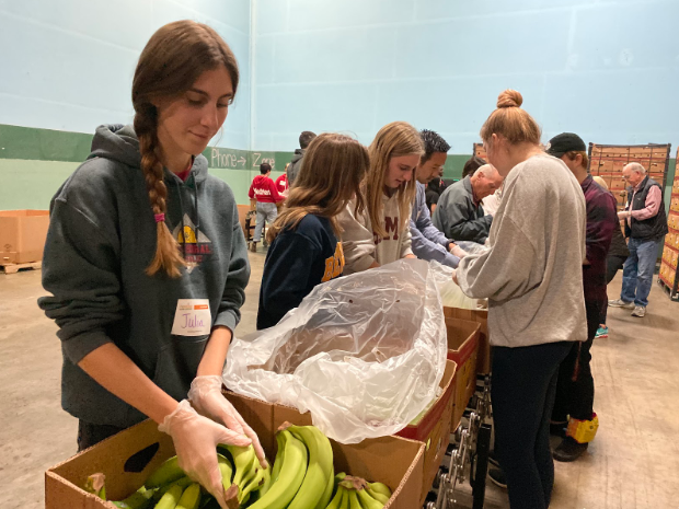 Julia Van Wey ‘20, Dani Plumb ‘20, Caroline Sutton ‘20, and RiAnna Wright ‘20 (left to right) work sorting bananas at the Feeding San Diego warehouse Tuesday. The seniors, along with approximately 15 others, attended the volunteer night in order to complete the Campus Ministry 12 service requirement. Feeding San Diego is a nonprofit organization that works to provide meals for San Diego’s homeless, impoverished, and marginalized community.