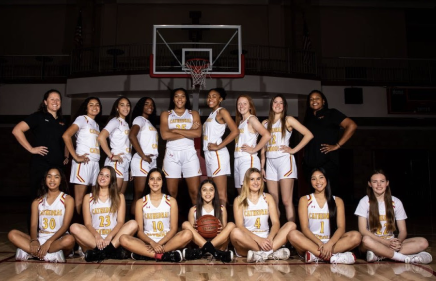 The+girls+varsity+basketball+team+lines+up+full-suited+for+team+pictures.