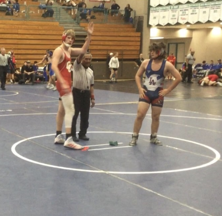 Cathedral+Catholic+High+School+wrestler+Nick+Palid+%E2%80%9821+is+appointed+the+winner+of+his+match+by+the+referee.