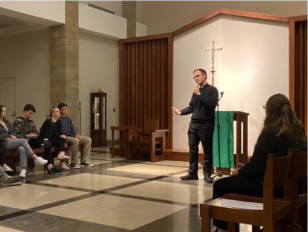 Father Paul de Soza, who is serving his first year as a Cathedral Catholic High School chaplain, speaks to the XLT attendees last Thursday before adoration and Benediction. CCHS Campus Ministry and Mission and Ministry celebrated this event, the first XLT night of the new year, in the chapel with approximately 40 students.