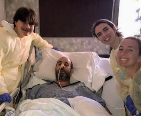 Mr. Jason Gilbert receives a visit from his three children Aden Gilbert ‘23, Alexa Gilbert ‘17, and Eliza Gilbert ‘19, (left to right) while recovering. 