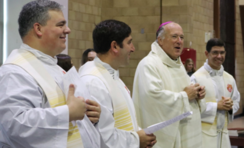 Bishop Robert McElroy stands alongside Cathedral Catholic High School’s priests during Mass, an event monitored by CCHS security guards. 