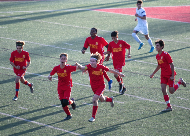 The CCHS junior varsity boys soccer team rejoices after Connor Douglas ‘22 scores the winning goal against Saint Augustine High School at CCHS in February.