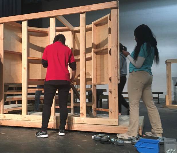 Students involved in drama tech work on set pieces for the upcoming musical Tuck Everlasting, in preparation for the show’s opening night on February 21. These preparations include  building, painting, setting props, and managing sound and lighting. 
