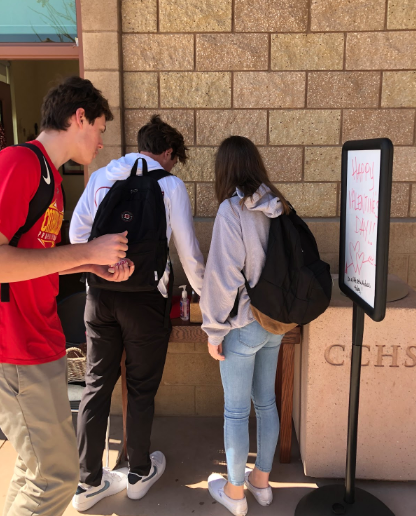 Cathedral Catholic High School students enjoy cookies and candy outside of the mission and ministry office on Valentine’s Day. 