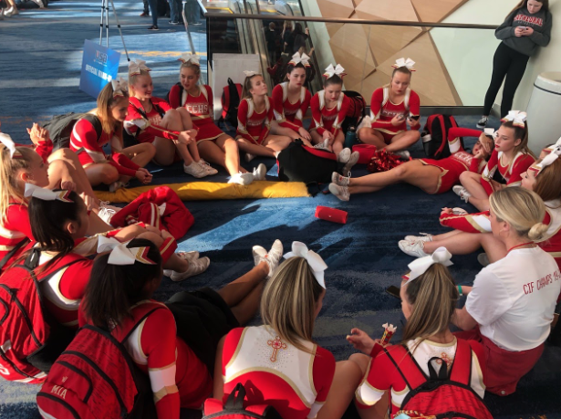 The Cathedral Catholic High School competition cheer team takes a break and debriefs while other teams compete in the Anaheim Convention Center on Friday. The team came in seventh place on Friday.