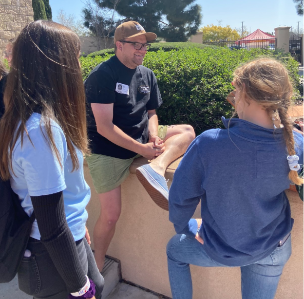 Mr. Harrison Trubitt discusses upcoming service opportunities for the St. Thérèse of Carmel youth ministry group. The dialogue occurred at lunch on Friday and the group offered pizza for attendees.