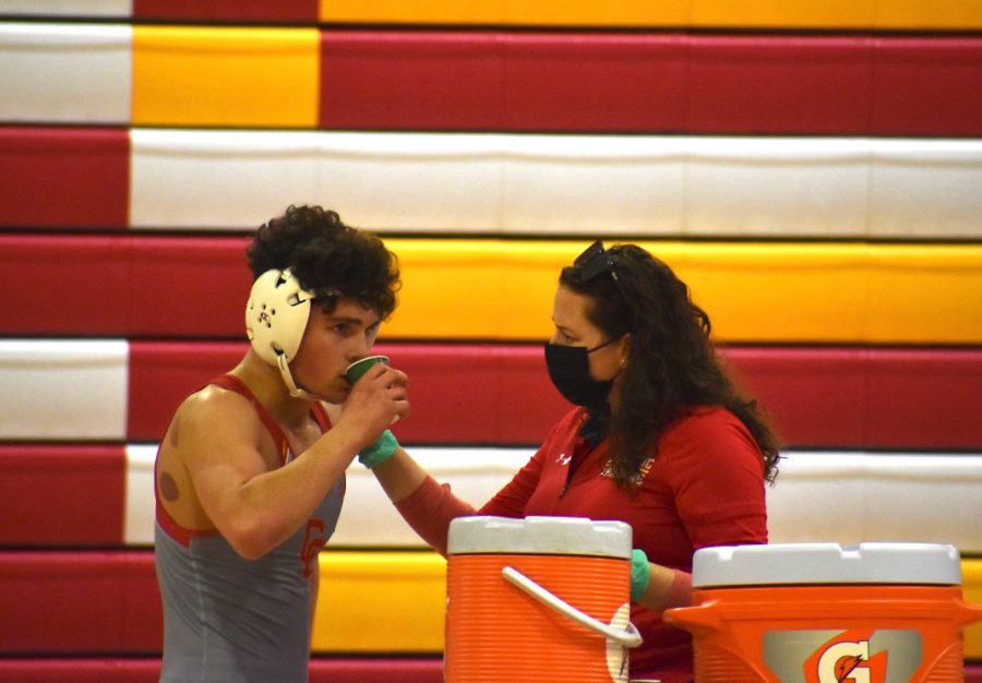 Ashley+Hurrell%2C+a+sports+med+trainer+at+CCHS%2C+assists+a+student-athlete+during+a+wrestling+match.