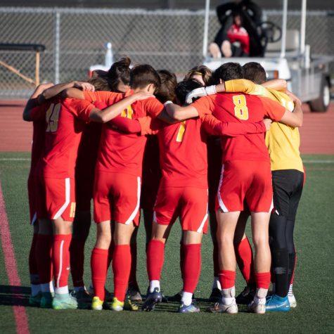 The starting players huddle together to prepare each other and mentally get into the zone before starting their game. These group pep talks fuel the fire inside of them to be motivated and ready to play.