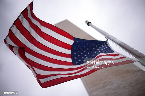 WASHINGTON, DC - MAY 12: Flags at the base of the Washington Monument fly at half staff as the United States nears the 1 millionth death attributed to COVID May 12, 2022 in Washington, DC. U.S. President ordered flags to fly at half-mast through next Monday and said the nation must stay resolved to fight the virus that has “forever changed” the country. (Photo by Win McNamee/Getty Images)