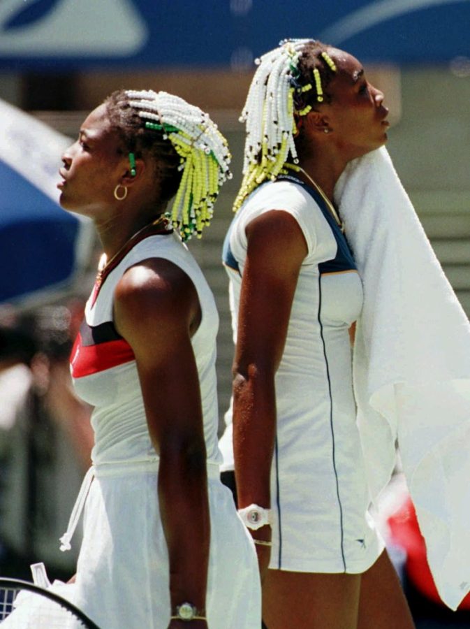 Serena Williams and Venus sharing a breath of relief after a match. This iconic picture was taken in 1996.