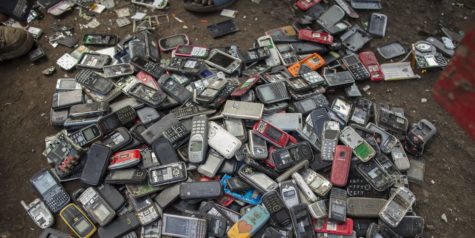 Pile of phones that have been thrown out rather than being refurbished. Millions of iPhones are thrown out and cause harm to the environment and remain unavailable to the underprivileged.