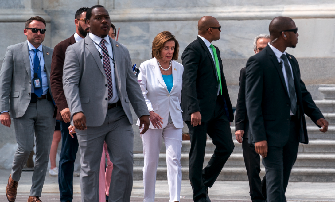 Nancy Pelosi with her security team after home invasion.