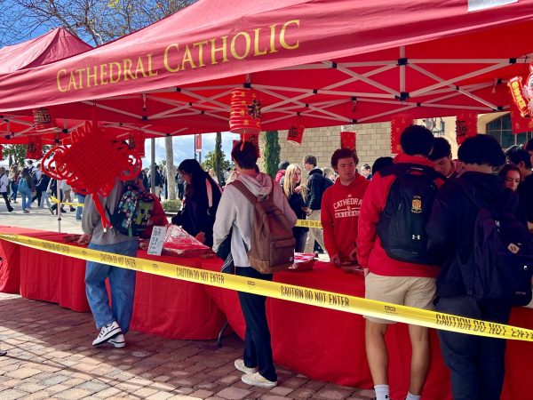 Students line up to receive various types of dumplings offered by members of the National Chinese Honors Society and Chinese Culture Club. Festive lanterns hang from the red tents, in celebration of a day filled with joy and laughter.