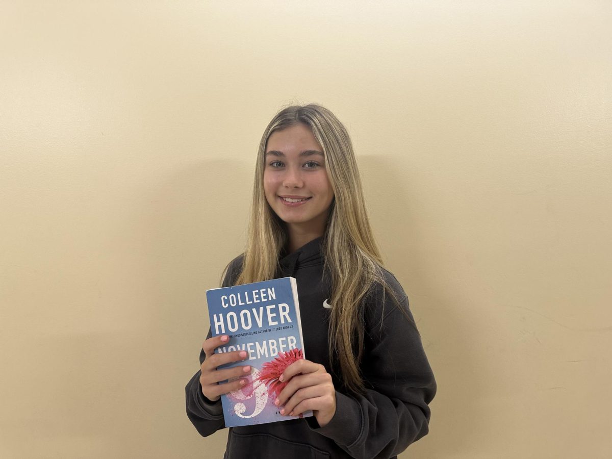 Cathedral Catholic sophomore, Lily Frenck, holding “November 9” by Colleen Hoover