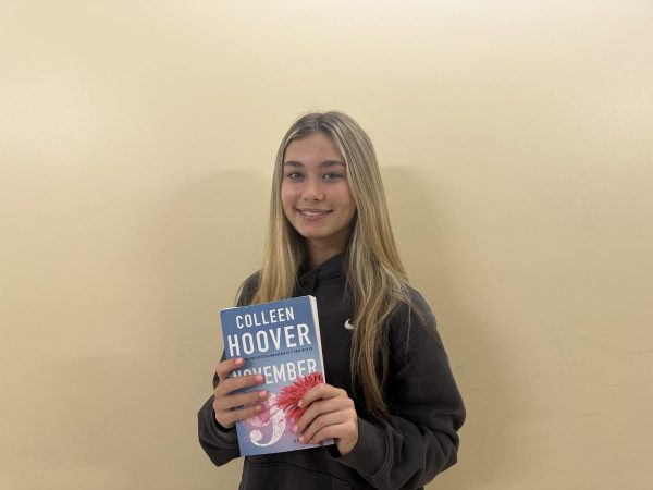 Cathedral Catholic sophomore, Lily Frenck, holding “November 9” by Colleen Hoover