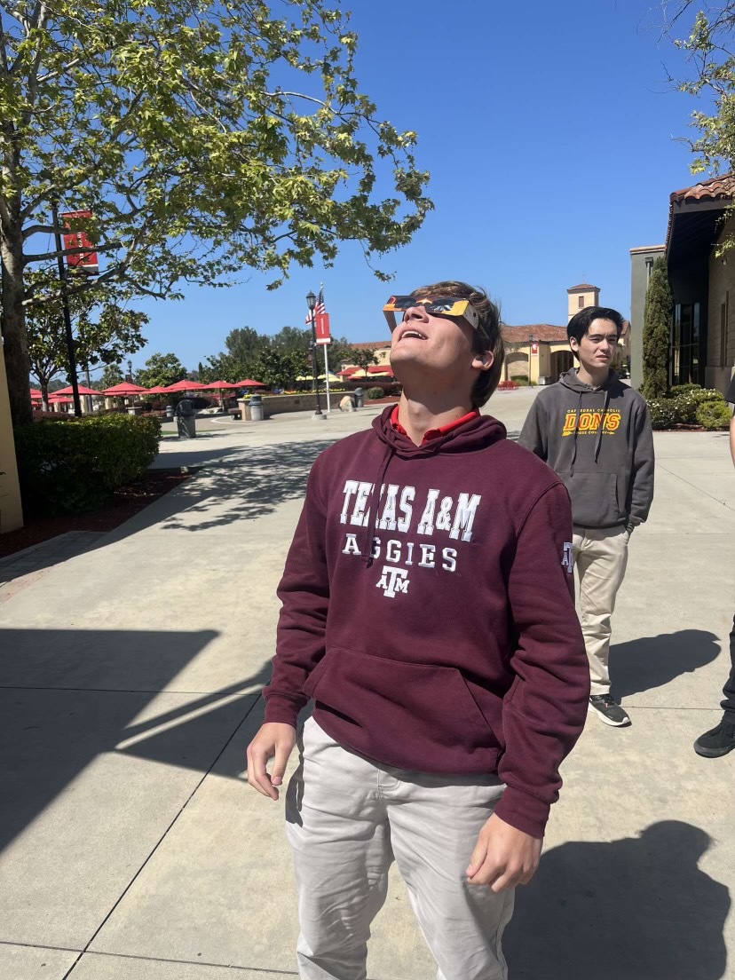Andrew Virissimo 24’ enjoying watching the solar eclipse outside of the classroom. 
