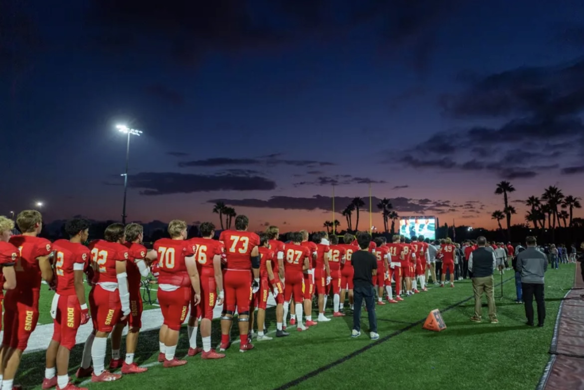 Currently 4-1, with the goal of winning the open division this year, the Boys' Football team stands for the Pledge of Allegiance prior to a game.

Photo by John Fraser