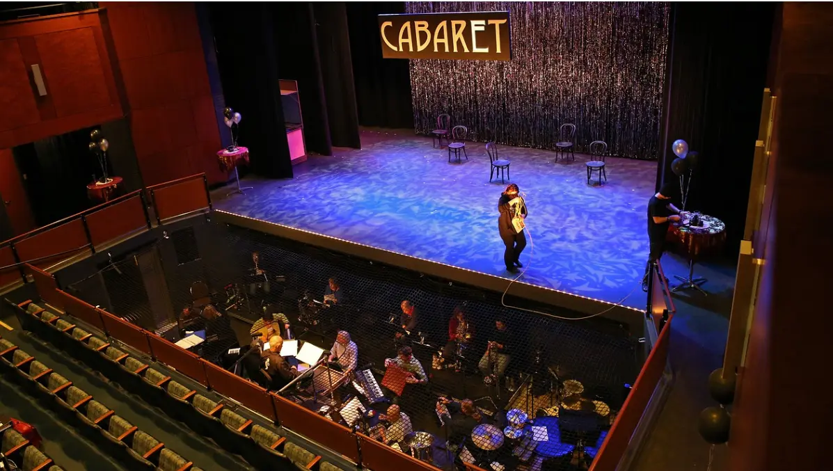 A Cabaret performance is a mixture of music and storytelling with a performer onstage accompanied by an orchestra down below.

Photo from Pixabay