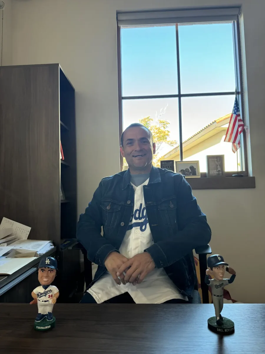 Lifelong Dodger fan Mr. Gonzalez with his Dodger bobble heads. Gonzalez celebrated the Dodgers' sweep of the Yankees in this latest World Series.