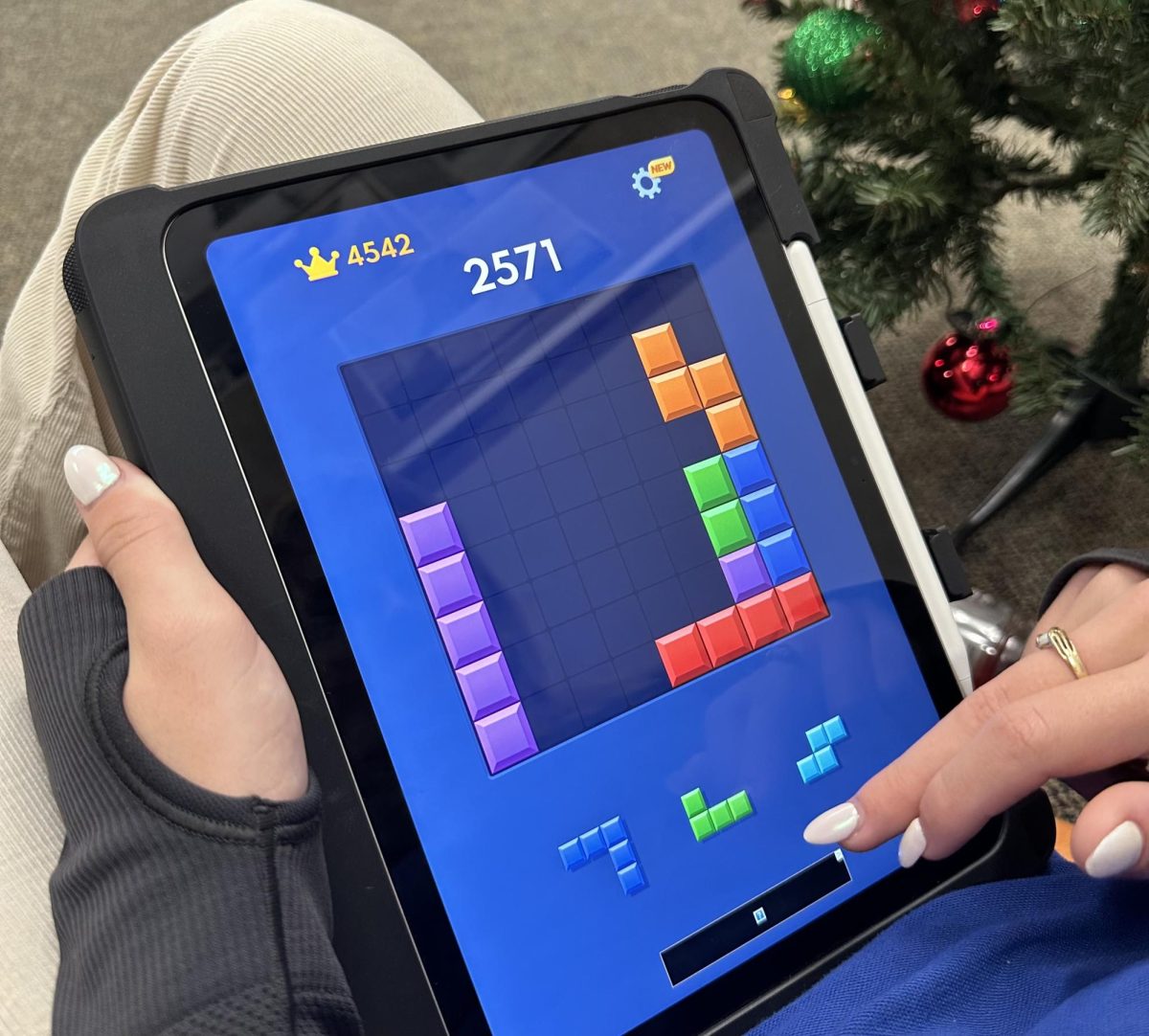 A player enjoys the addictive puzzle game—Block Blast!— from the comfort of their iPad during one of their breaks.
