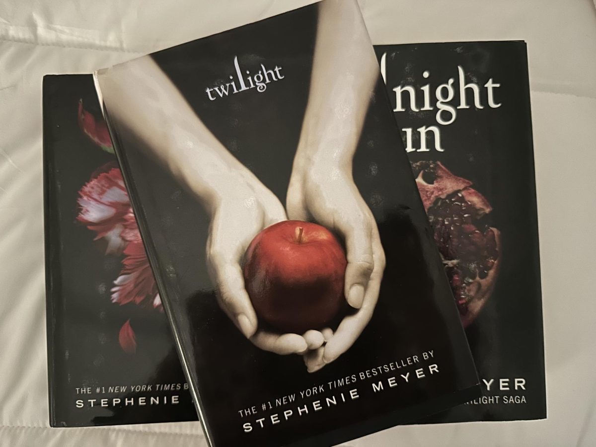 A photo of the book "Twilight" by Stephenie Meyer, featuring the iconic cover which symbolizes temptation and forbidden love, central themes in the story.

Photo by Emily Kovarik