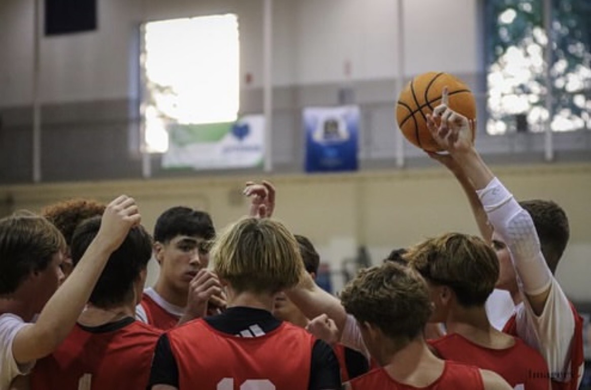 Boys varsity basketball team huddling up during the Philly Live tournament in Philadelphia over the summer.
