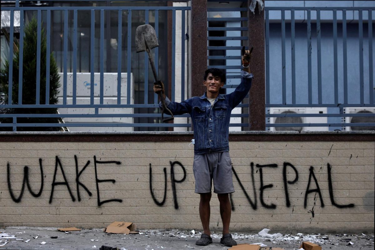 Sabin Tamang, 20, who works in a restaurant and participated in a Gen-Z protest, holds up a shovel while posing for a photograph next to a graffiti as he takes part in a cleaning campaign following Monday's deadly anti-corruption protests in Kathmandu, Nepal, September 10, 2025. "To develop our country, we need to choose good people instead of choosing relatives"'  said Sabin Tamang. We should hand over the future of the country to a person who has good ideology and is not self-centred." REUTERS/Navesh Chitrakar TPX IMAGES OF THE DAY