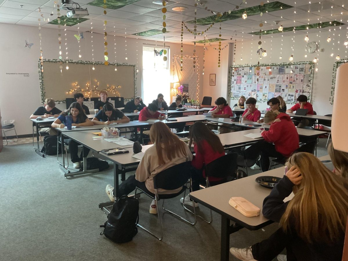College Poetry students studiously crafting a poetry piece.